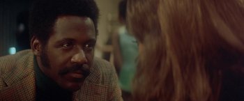 Movie still from “Shaft's Big Score!” (1972), directed by Gordon Parks – A man and a woman are talking to each other in a room; Close Up shot, Over the shoulder angle