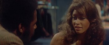 Movie still from “Shaft's Big Score!” (1972), directed by Gordon Parks – A man and a woman talking to each other; Close Up shot, Over the shoulder angle