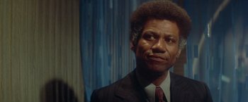 Movie still from “Shaft's Big Score!” (1972), directed by Gordon Parks – A man in a suit and a tie; Close Up shot, Low angle