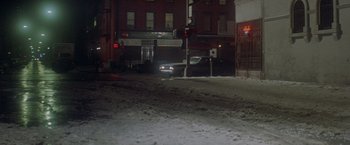 Movie still from “Shaft's Big Score!” (1972), directed by Gordon Parks – A car is stopped at a red light at night; Extreme Wide shot, High angle