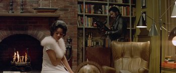 Movie still from “Shaft's Big Score!” (1972), directed by Gordon Parks – A man and a woman sitting in a living room; Medium shot, Over the shoulder angle
