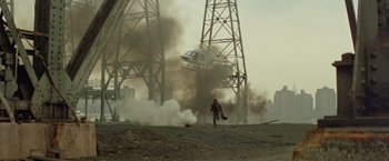 Movie still from “Shaft's Big Score!” (1972), directed by Gordon Parks – Smoke billows from a train as a man walks away from it; Extreme Wide shot, Low angle
