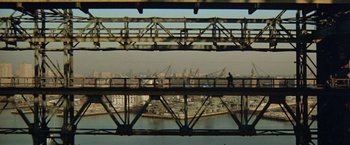 Movie still from “Shaft's Big Score!” (1972), directed by Gordon Parks – A person is walking on a bridge over a river; Extreme Wide shot, High angle