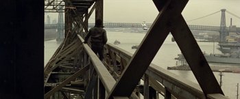 Movie still from “Shaft's Big Score!” (1972), directed by Gordon Parks – A man standing on a bridge looking out over the water; Extreme Wide shot, High angle