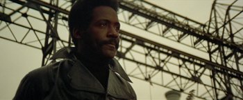 Movie still from “Shaft's Big Score!” (1972), directed by Gordon Parks – A person wearing a jacket; Close Up shot, Low angle