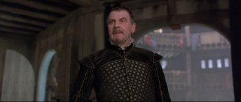 Movie still from “Shakespeare in Love” (1998), directed by John Madden – A person wearing a suit and tie; Close Up shot, Low angle