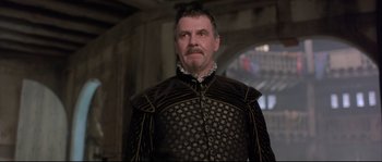 Movie still from “Shakespeare in Love” (1998), directed by John Madden – A person wearing a suit; Close Up shot, Low angle