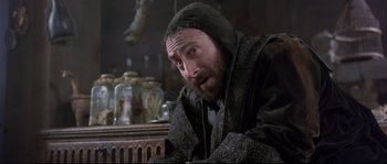 Movie still from “Shakespeare in Love” (1998), directed by John Madden – A man with a beard wearing a black jacket; Close Up shot, Low angle