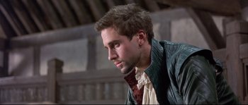 Movie still from “Shakespeare in Love” (1998), directed by John Madden – A man in a leather jacket looking to his left; Close Up shot, Over the shoulder angle