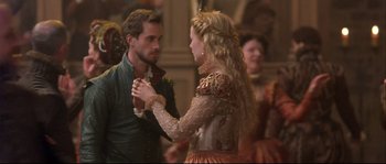Movie still from “Shakespeare in Love” (1998), directed by John Madden – A man and a woman are dancing in front of a crowd; Medium shot, Over the shoulder angle