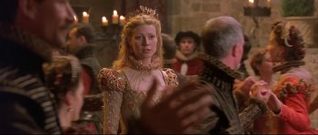 Movie still from “Shakespeare in Love” (1998), directed by John Madden – A woman wearing a crown and a dress; Medium shot, Over the shoulder angle