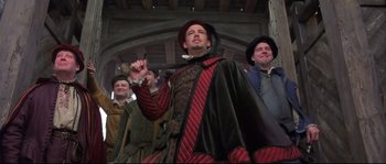 Movie still from “Shakespeare in Love” (1998), directed by John Madden – A group of men standing next to each other in costumes; Medium shot, Low angle