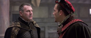 Movie still from “Shakespeare in Love” (1998), directed by John Madden – Two men in medieval garb talking to each other; Close Up shot, Over the shoulder angle