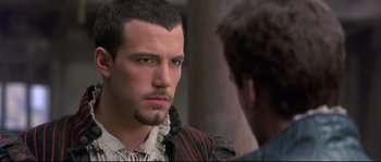 Movie still from “Shakespeare in Love” (1998), directed by John Madden – A person with a beard; Close Up shot, Over the shoulder angle