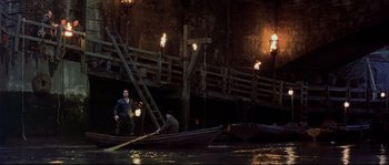 Movie still from “Shakespeare in Love” (1998), directed by John Madden – Two people in a boat on a body of water at night; Wide shot, High angle