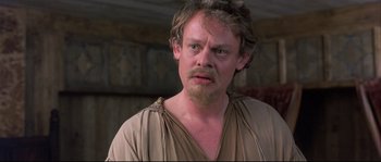 Movie still from “Shakespeare in Love” (1998), directed by John Madden – A person with a beard; Close Up shot, Over the shoulder angle