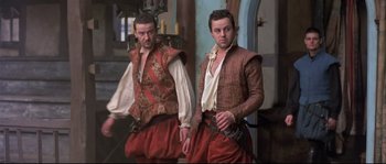 Movie still from “Shakespeare in Love” (1998), directed by John Madden – A couple of men standing next to each other; Medium shot, Low angle
