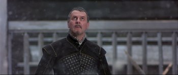 Movie still from “Shakespeare in Love” (1998), directed by John Madden – A man in a black and gold outfit looking to his left; Close Up shot, Low angle