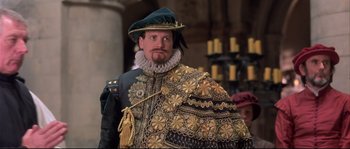Movie still from “Shakespeare in Love” (1998), directed by John Madden – A man dressed as a renaissance man in a costume; Medium shot, Over the shoulder angle