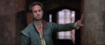 Movie still from “Shakespeare in Love” (1998), directed by John Madden – A man in a leather jacket pointing at the camera; Close Up shot, Over the shoulder angle