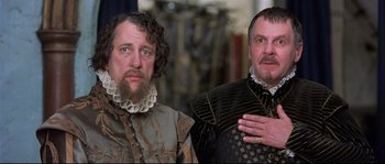 Movie still from “Shakespeare in Love” (1998), directed by John Madden – Two men dressed in renaissance clothing posing for a picture; Close Up shot, Low angle