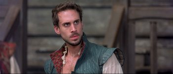 Movie still from “Shakespeare in Love” (1998), directed by John Madden – A person with a beard; Close Up shot, Over the shoulder angle