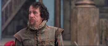 Movie still from “Shakespeare in Love” (1998), directed by John Madden – A person wearing a costume; Close Up shot, Over the shoulder angle