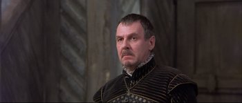 Movie still from “Shakespeare in Love” (1998), directed by John Madden – A person wearing a suit and a beard; Close Up shot, Low angle