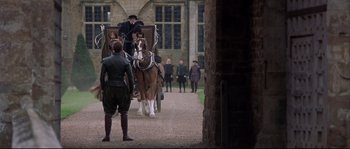 Movie still from “Shakespeare in Love” (1998), directed by John Madden – A horse drawn carriage is being driven by a man; Wide shot, Over the shoulder angle