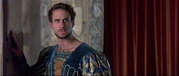 Movie still from “Shakespeare in Love” (1998), directed by John Madden – A person wearing a costume; Close Up shot, Over the shoulder angle
