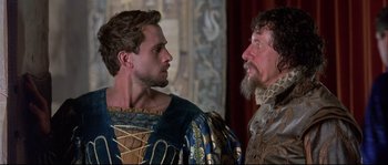 Movie still from “Shakespeare in Love” (1998), directed by John Madden – Two men in medieval garb talking to each other; Close Up shot, Over the shoulder angle