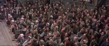 Movie still from “Shakespeare in Love” (1998), directed by John Madden – A large group of people are gathered in a room; Wide shot, High angle