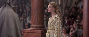 Movie still from “Shakespeare in Love” (1998), directed by John Madden – A beautiful young lady wearing a gold dress; Medium shot, Over the shoulder angle