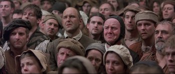 Movie still from “Shakespeare in Love” (1998), directed by John Madden – A group of people that are standing in a room; Medium shot, High angle