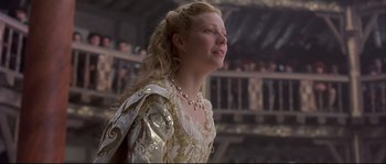 Movie still from “Shakespeare in Love” (1998), directed by John Madden – A woman in a white and gold dress looking up; Close Up shot, Low angle