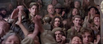 Movie still from “Shakespeare in Love” (1998), directed by John Madden – A group of people sitting in a room; Medium shot, High angle