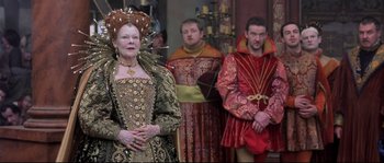 Movie still from “Shakespeare in Love” (1998), directed by John Madden – A group of people dressed up in costumes; Medium shot, Over the shoulder angle