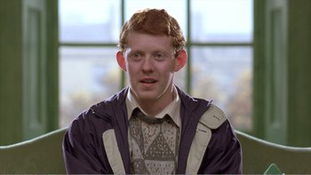 Movie still from “Shallow Grave” (1994), directed by Danny Boyle – A young man with red hair wearing a sweater and a jacket; Close Up shot, Over the shoulder angle