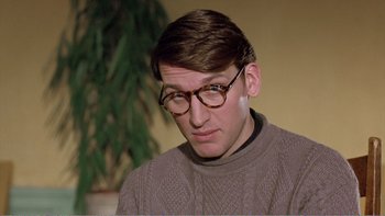 Movie still from “Shallow Grave” (1994), directed by Danny Boyle – A man wearing glasses and a brown sweater; Close Up shot, Over the shoulder angle