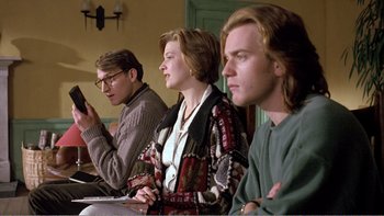 Movie still from “Shallow Grave” (1994), directed by Danny Boyle – A group of young people sitting in a room together; Medium shot, Low angle