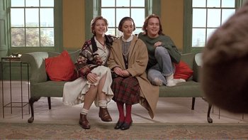 Movie still from “Shallow Grave” (1994), directed by Danny Boyle – A group of people sitting on top of a couch; Wide shot, Low angle