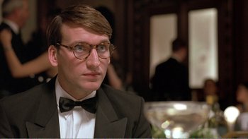 Movie still from “Shallow Grave” (1994), directed by Danny Boyle – A person wearing glasses and a bow tie; Close Up shot, Low angle