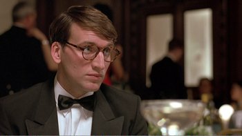 Movie still from “Shallow Grave” (1994), directed by Danny Boyle – A man in a suit and bow tie looking to his left; Close Up shot, Low angle