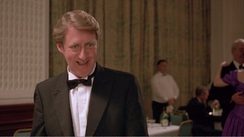 Movie still from “Shallow Grave” (1994), directed by Danny Boyle – A man in a tuxedo standing in front of a table; Close Up shot, Low angle