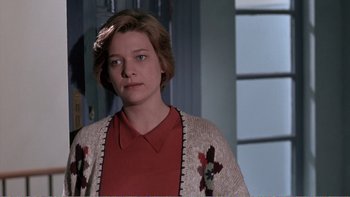 Movie still from “Shallow Grave” (1994), directed by Danny Boyle – A woman in a red shirt and a sweater; Close Up shot, Over the shoulder angle