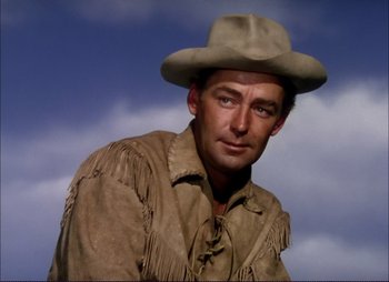 Movie still from “Shane” (1953), directed by George Stevens – A man wearing a cowboy hat and fringed jacket; Close Up shot, Low angle
