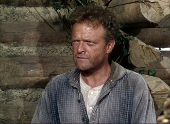 Movie still from “Shane” (1953), directed by George Stevens – A person wearing a shirt near a wall; Close Up shot, Over the shoulder angle