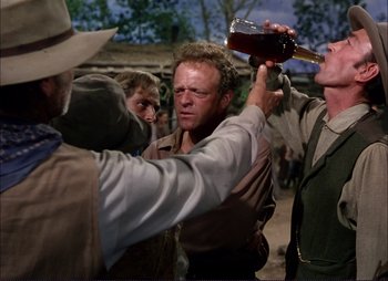 Movie still from “Shane” (1953), directed by George Stevens – A group of men standing next to each other; Medium shot, Over the shoulder angle