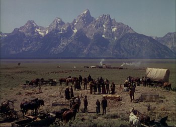 Movie still from “Shane” (1953), directed by George Stevens – A group of people standing in the middle of a field; Extreme Wide shot, High angle
