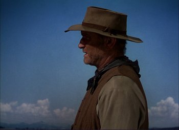 Movie still from “Shane” (1953), directed by George Stevens – An older man wearing a cowboy hat in the middle of the day; Medium shot, Low angle